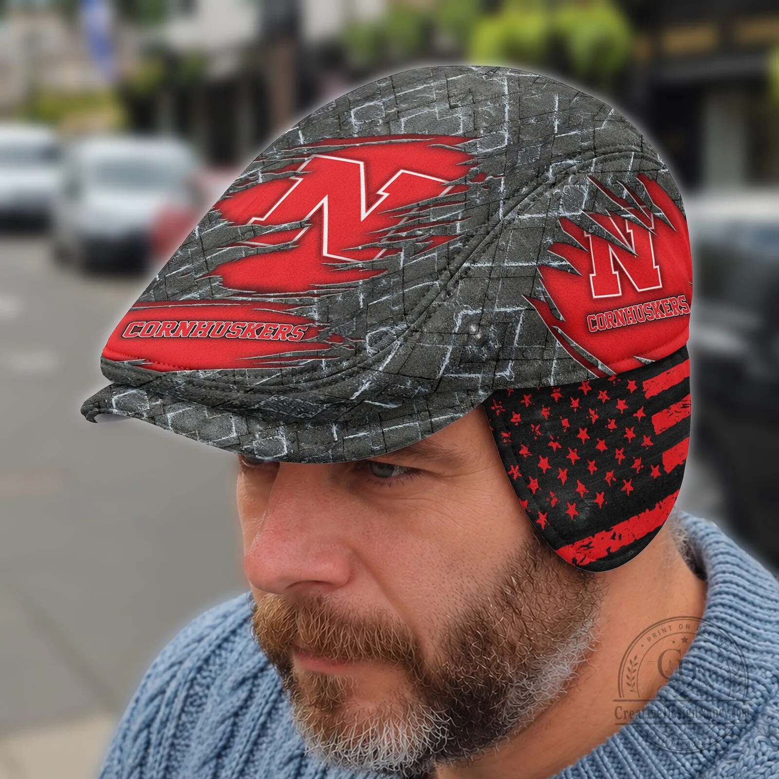 NCAA Flat Cap featuring Foldable Ear Flaps - Nebraska Cornhuskers Design